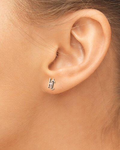 hearing, health, beauty and piercing concept - close up of woman's ear